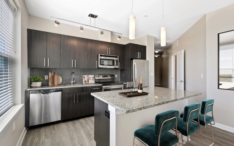 a kitchen with an island and chairs