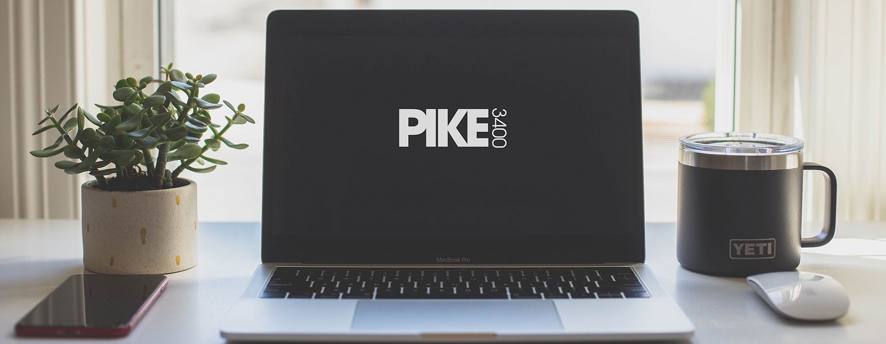 lifestyle image of a laptop displaying the Pike 3400 logo