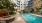 swimming pool with spacious seating areas and reclining chairs