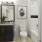 Bathroom at our Arlington apartments featuring toilet, shower/bath, and a porcelain sink with a plant on it.